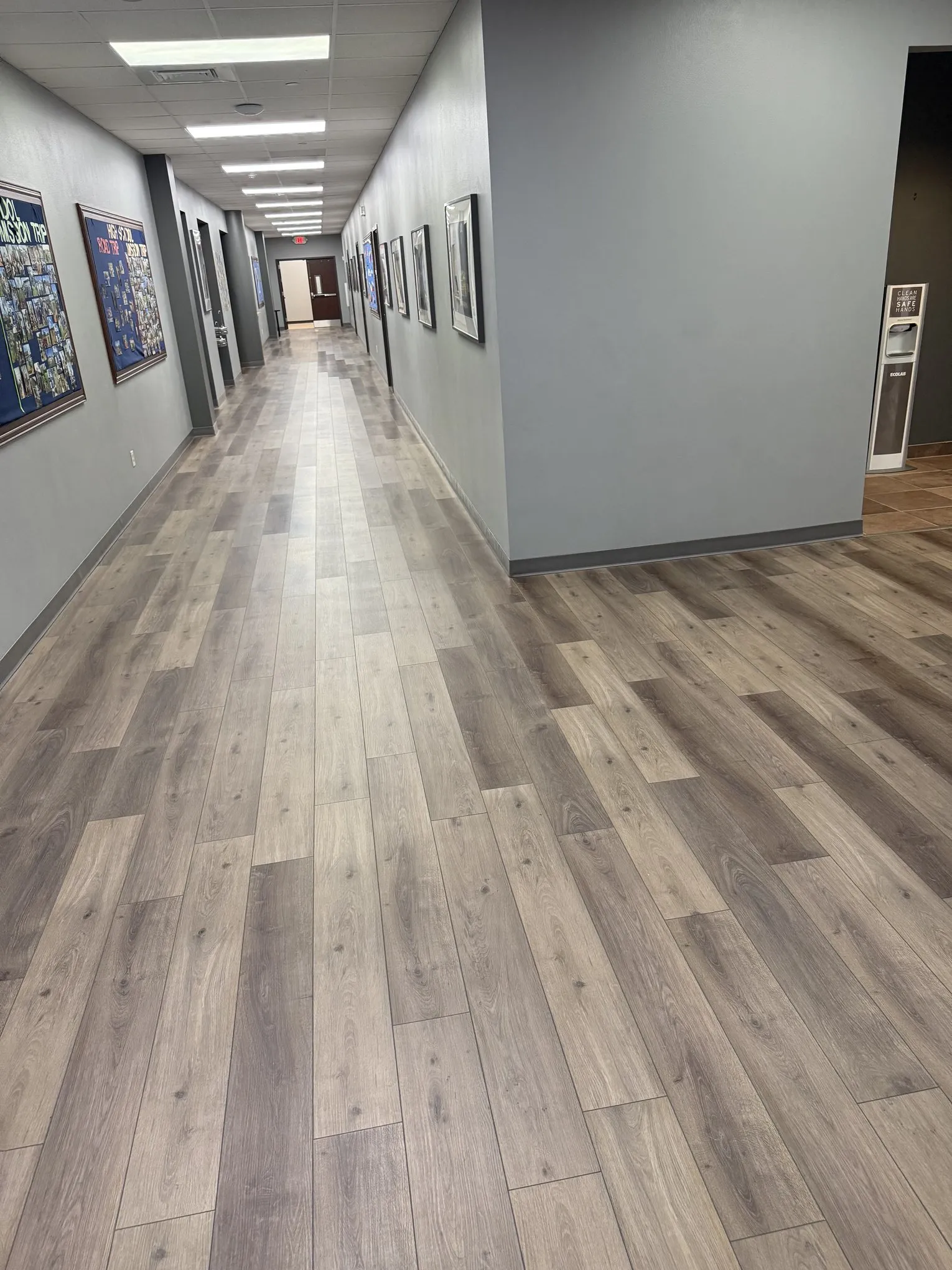 Commercial hallway with clean floors maintained by Frisco Brothers
