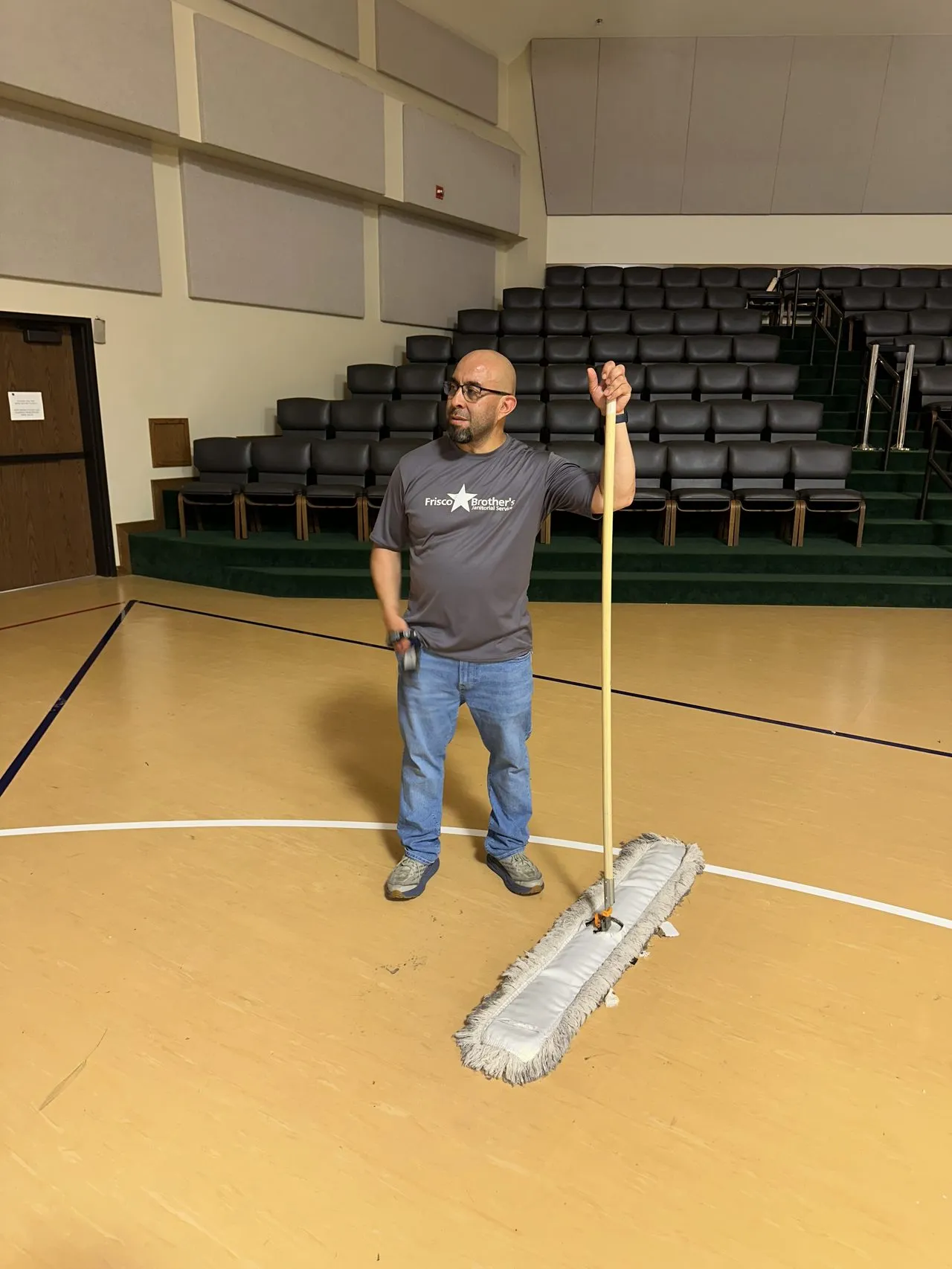 Dust-mopping a gym floor